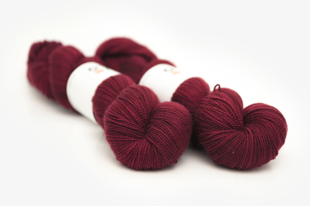 semisolid hand dyed sangria (dark wine burgundy red) merino sock yarn