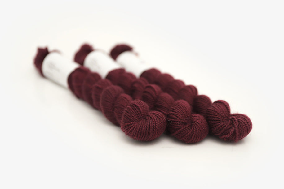 semisolid hand dyed sangria (dark wine burgundy red) merino sock mini yarn