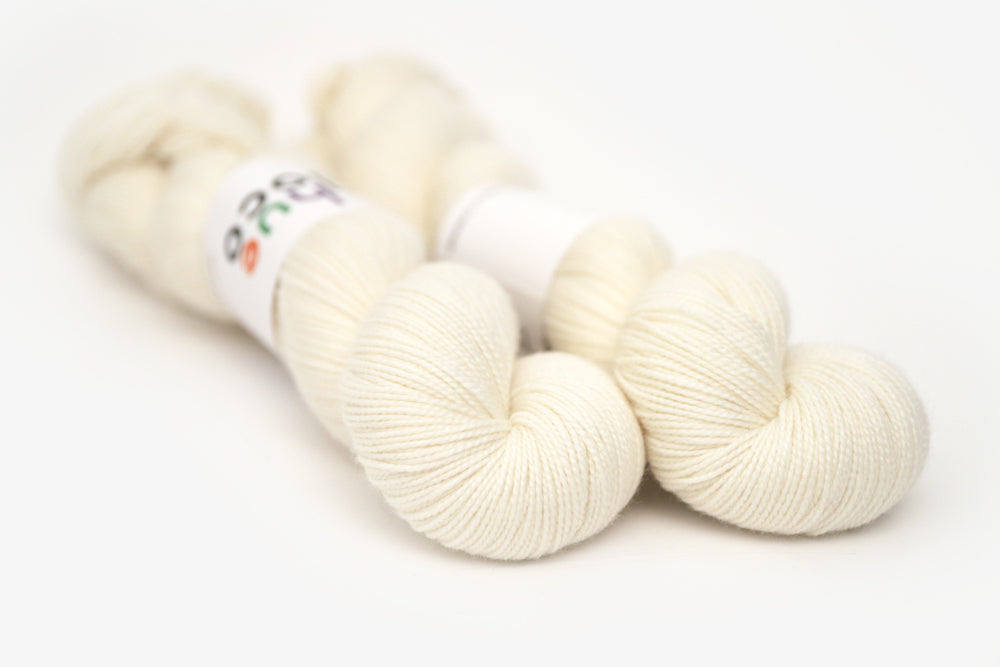 semisolid hand dyed ivory white merino sock yarn