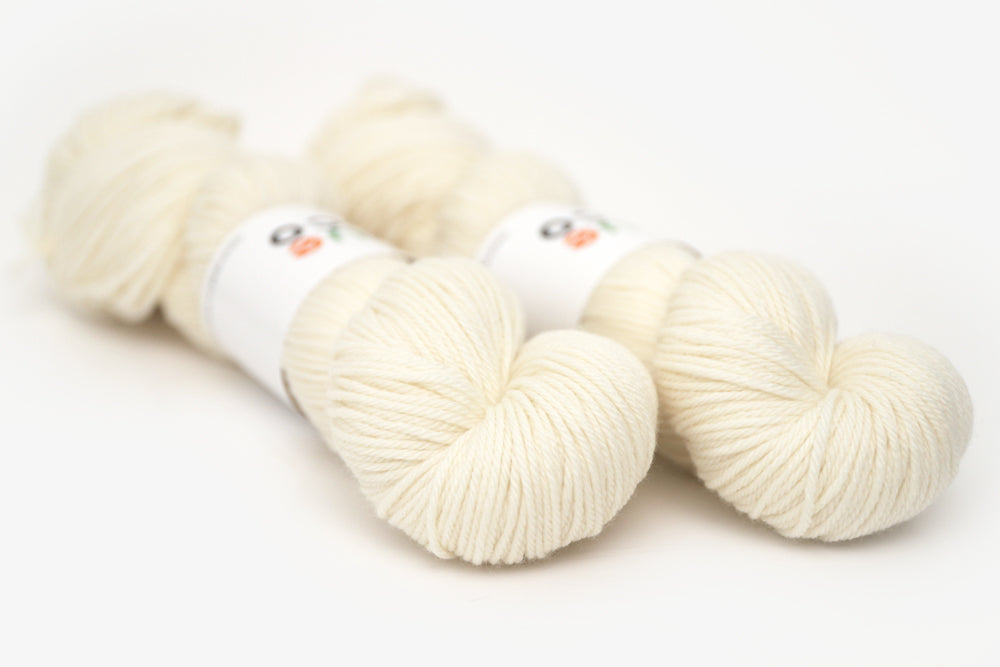 semisolid hand dyed ivory white worsted yarn