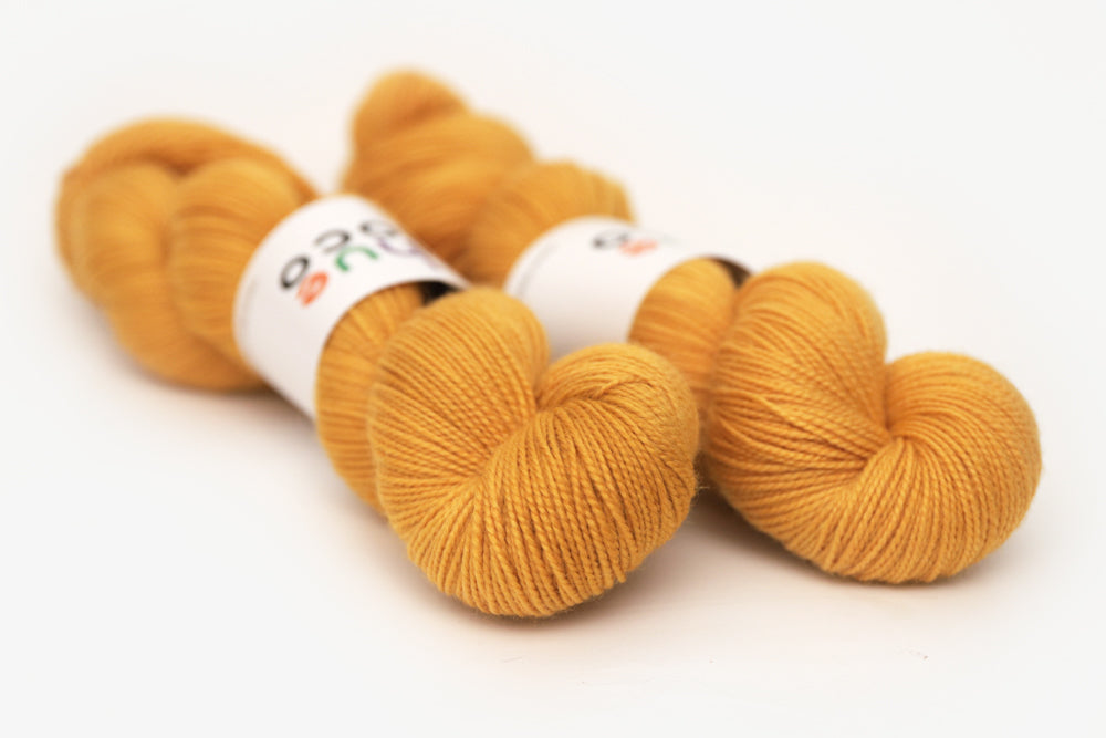 semisolid hand dyed squash (mustard gold yellow) merino sock yarn