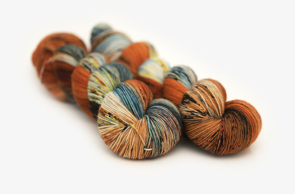 speckled hand dyed burnt orange teal green phyllis sock yarn