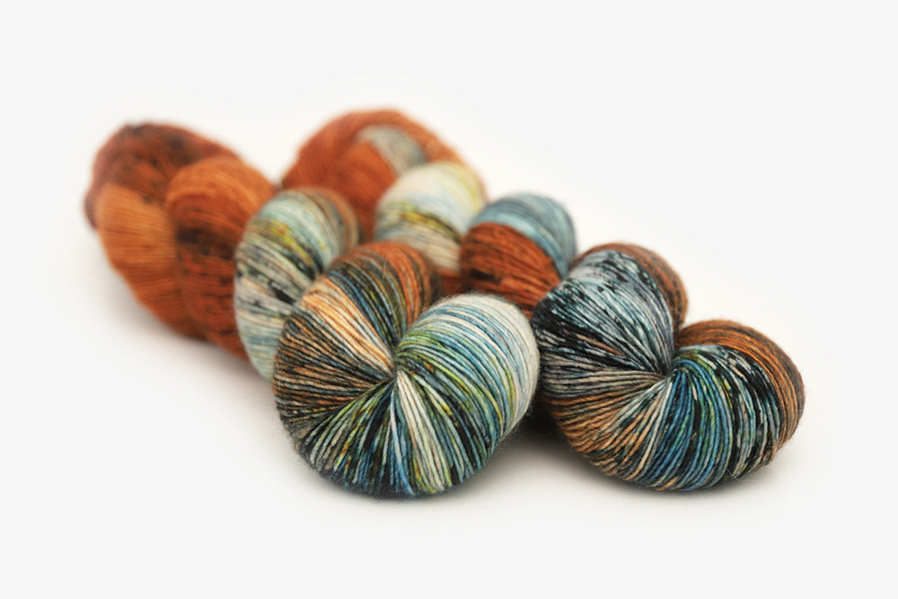 speckled hand dyed burnt orange teal green single sock yarn