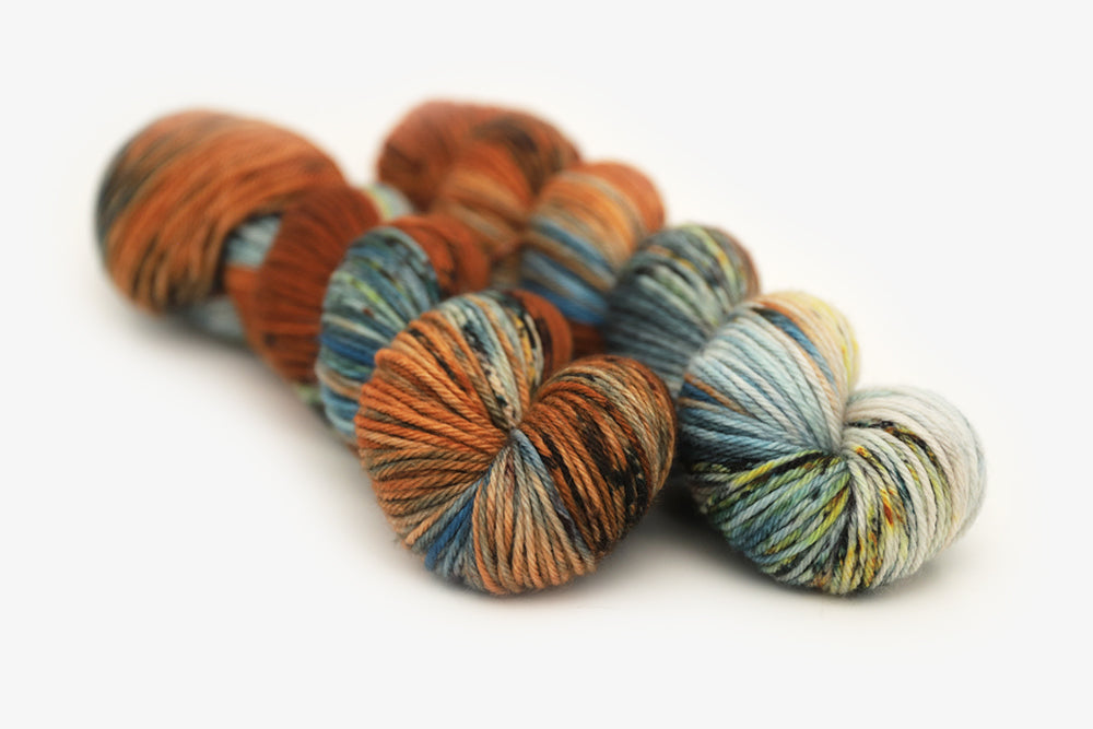 speckled hand dyed burnt orange teal green worsted yarn